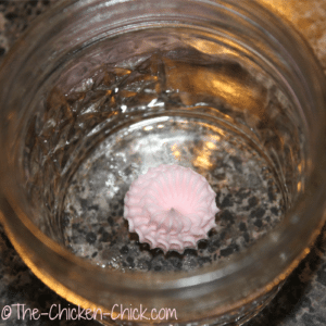Add dot of frosting to bottom of jar